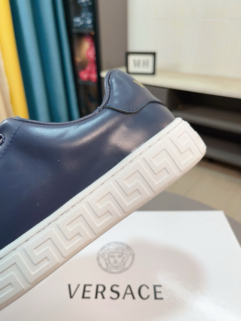 Versace sneakers side view in dark navy with white geometric tread sole