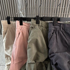 Cargo shorts on hangers with front pockets in cream, pink, olive, and dark gray
