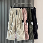 Cargo shorts assortment on hangers in cream, pink, olive, and black