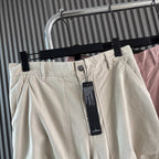Stone Island cream cargo shorts with button front, waistband, and hanging tag
