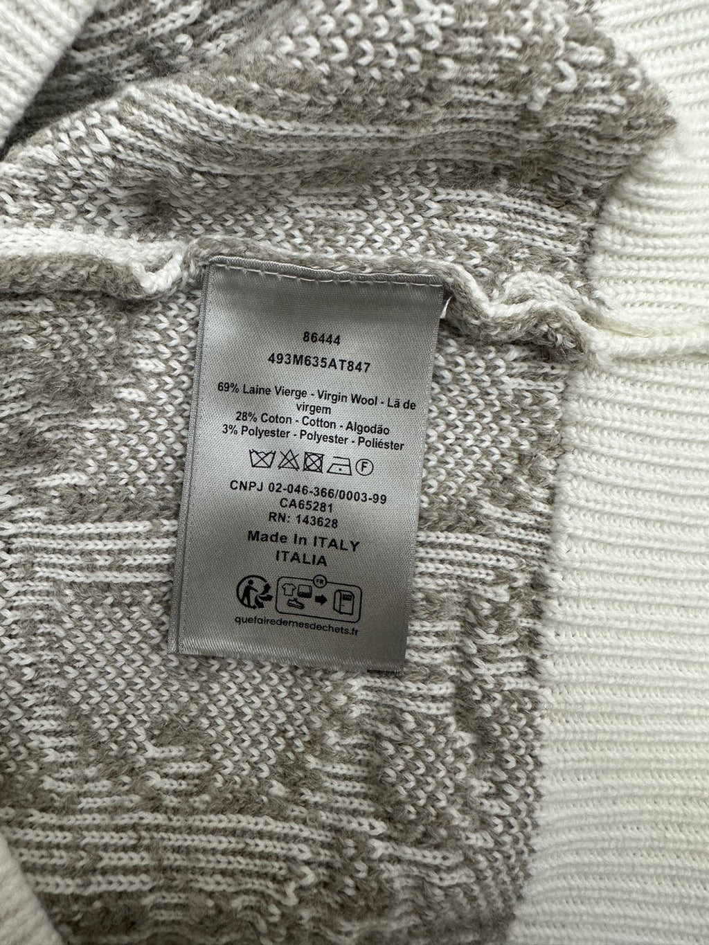 Inner label on knit sweater in gray and white patterned fabric; Made in Italy