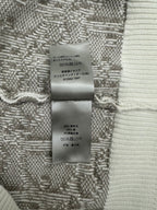 Inner care label on knit sweater fabric in gray and white with Japanese text