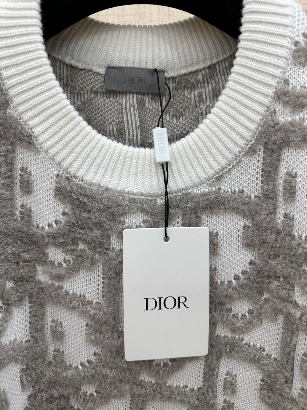 Ribbed crew-neck sweater with light gray and white logo-like jacquard pattern; Dior tag