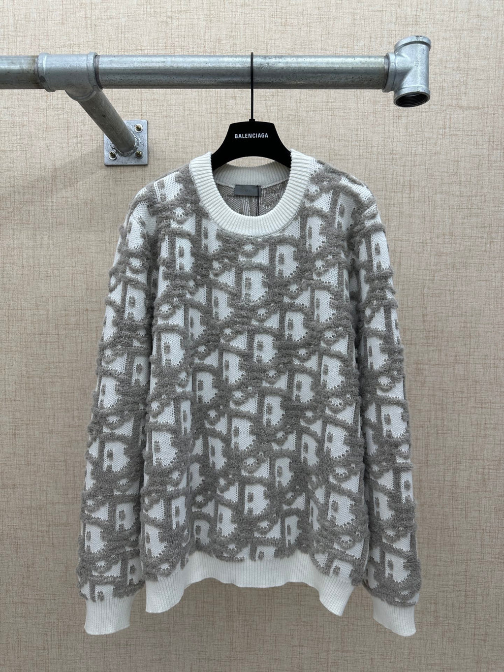 Long-sleeve knit sweater in light gray with allover logo-like print and ribbed hem