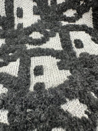 Close-up of black and white patterned knit fabric with textured finish