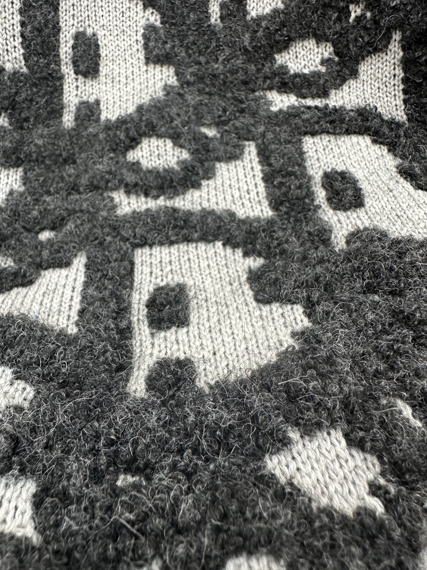 Close-up of black and white patterned knit fabric with textured finish