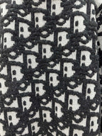 Close-up of black and white monogram knit texture on sweater