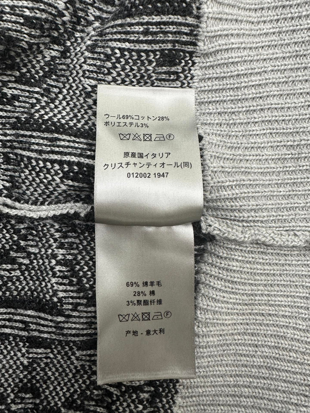 Fabric care label on black and white patterned knit sweater