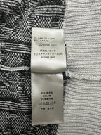 Fabric care label on black and white patterned knit sweater
