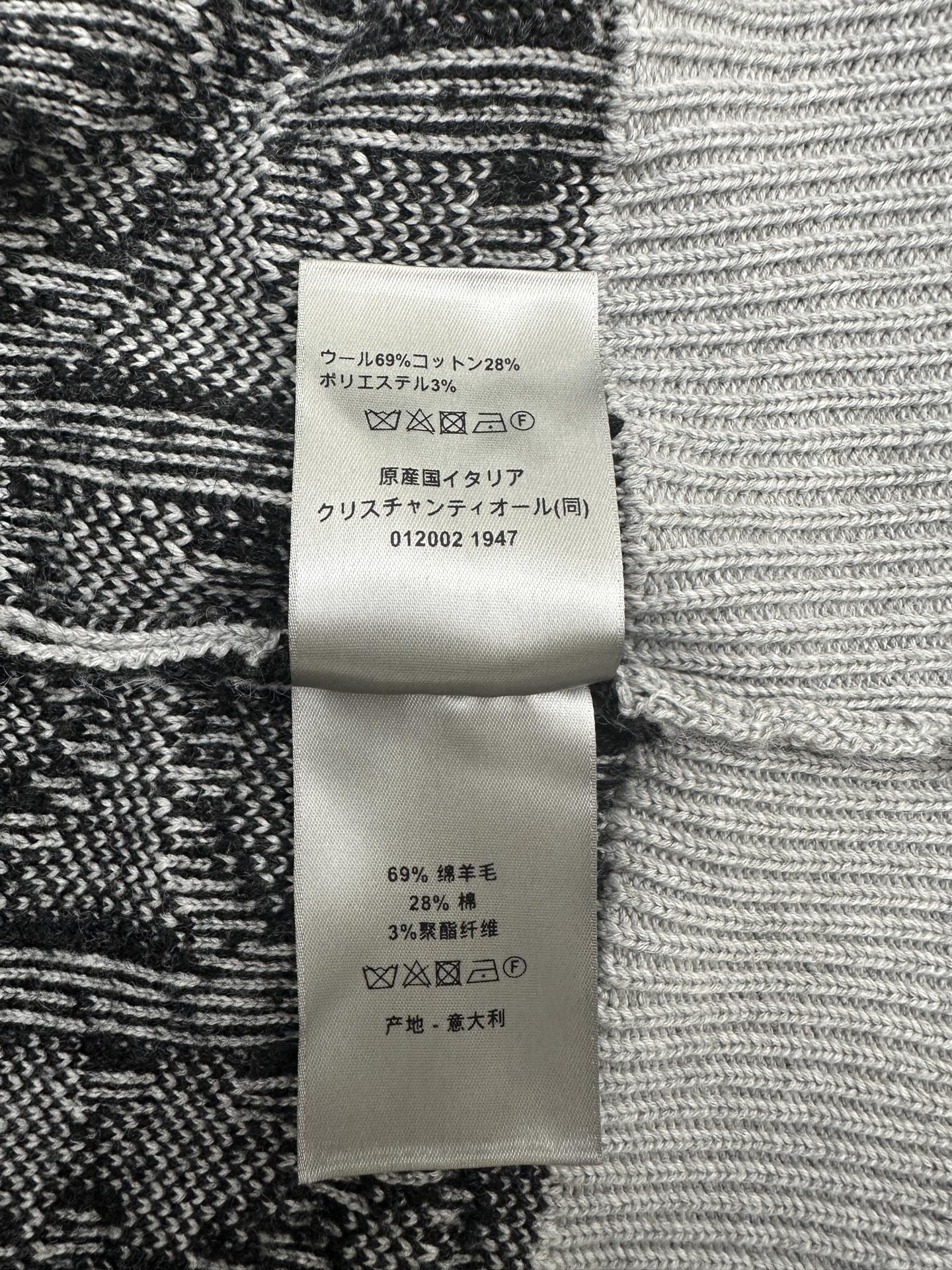 Fabric care label on black and white patterned knit sweater