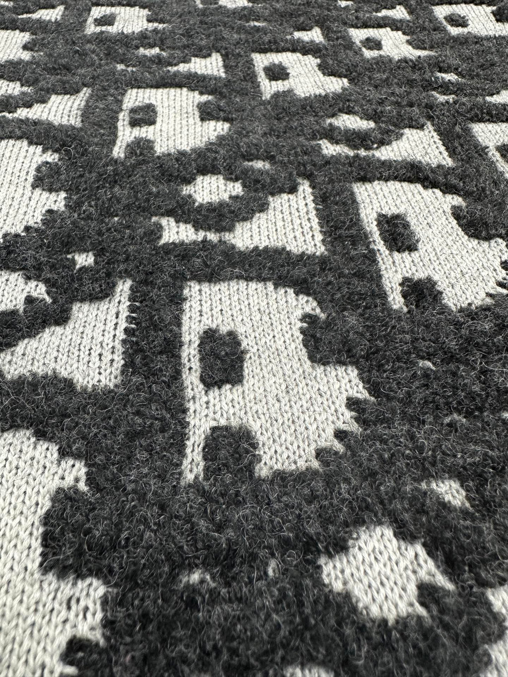 Black and white monogram jacquard knit fabric panel, high-contrast pattern