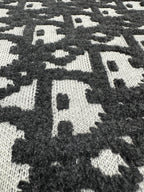 Black and white monogram jacquard knit fabric panel, high-contrast pattern
