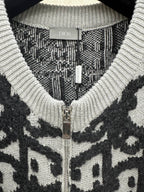Dior jacquard knit cardigan close-up, metal zipper and ribbed V-neck, dark/white