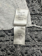 Clothing care label on knit cardigan, with fabric composition text