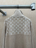 Beige hoodie back with white monogram pattern across shoulders