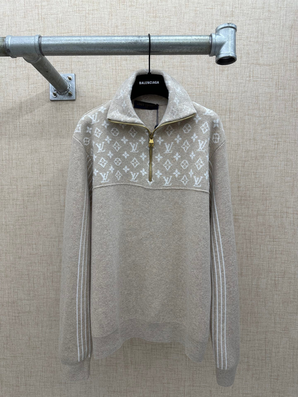 Beige long-sleeve hoodie with white monogram pattern, half-zip and hood