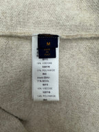 Beige fabric care label with material percentages, including viscose and wool