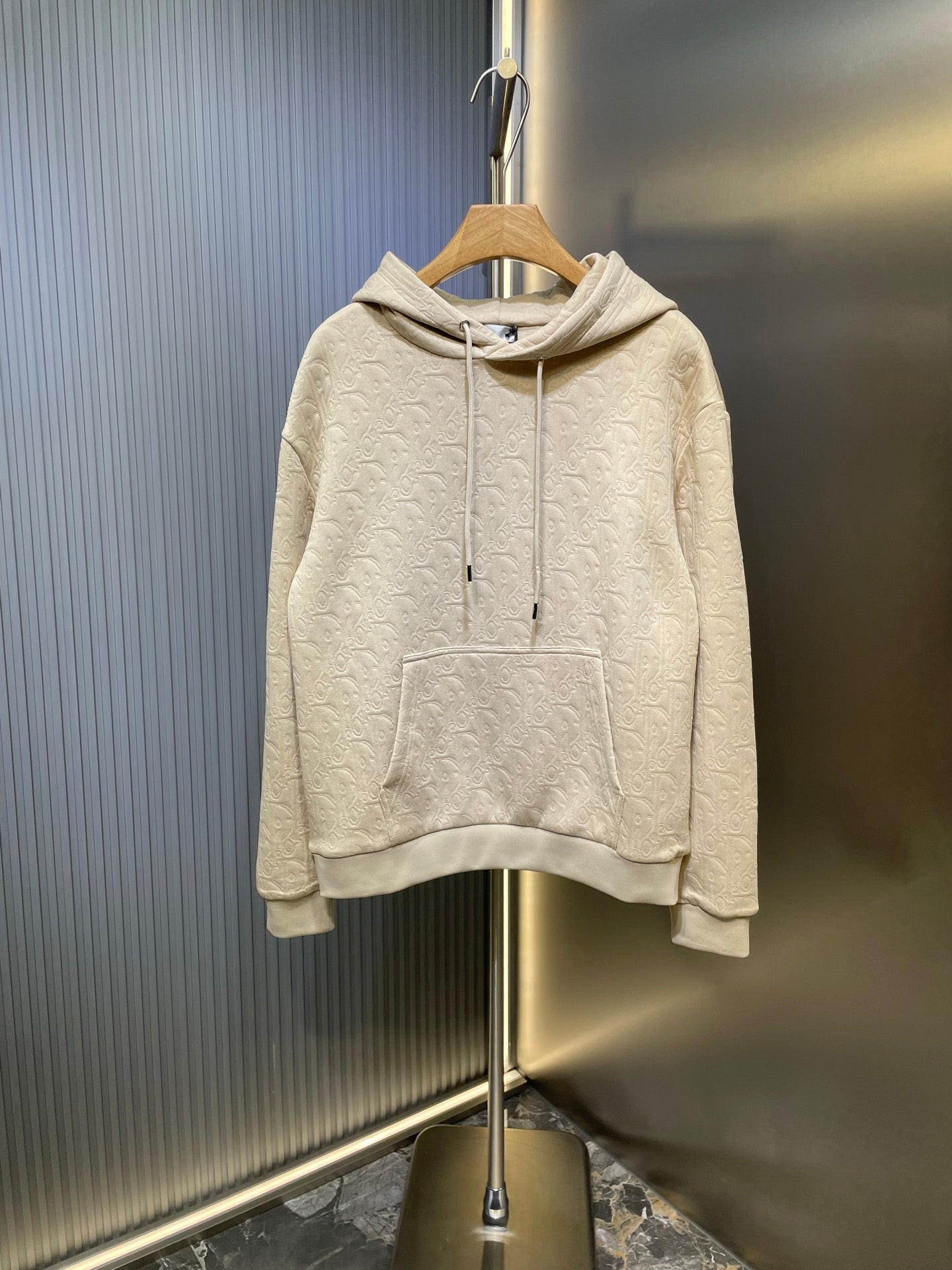 Cream Dior embossed hoodie with drawstring hood and front pocket
