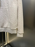 Cream embossed hoodie with kangaroo pocket and center front seam