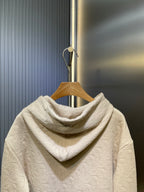Cream embossed hoodie with attached hood, shown from the back