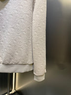 Cream embossed hoodie hem and sleeve cuffs