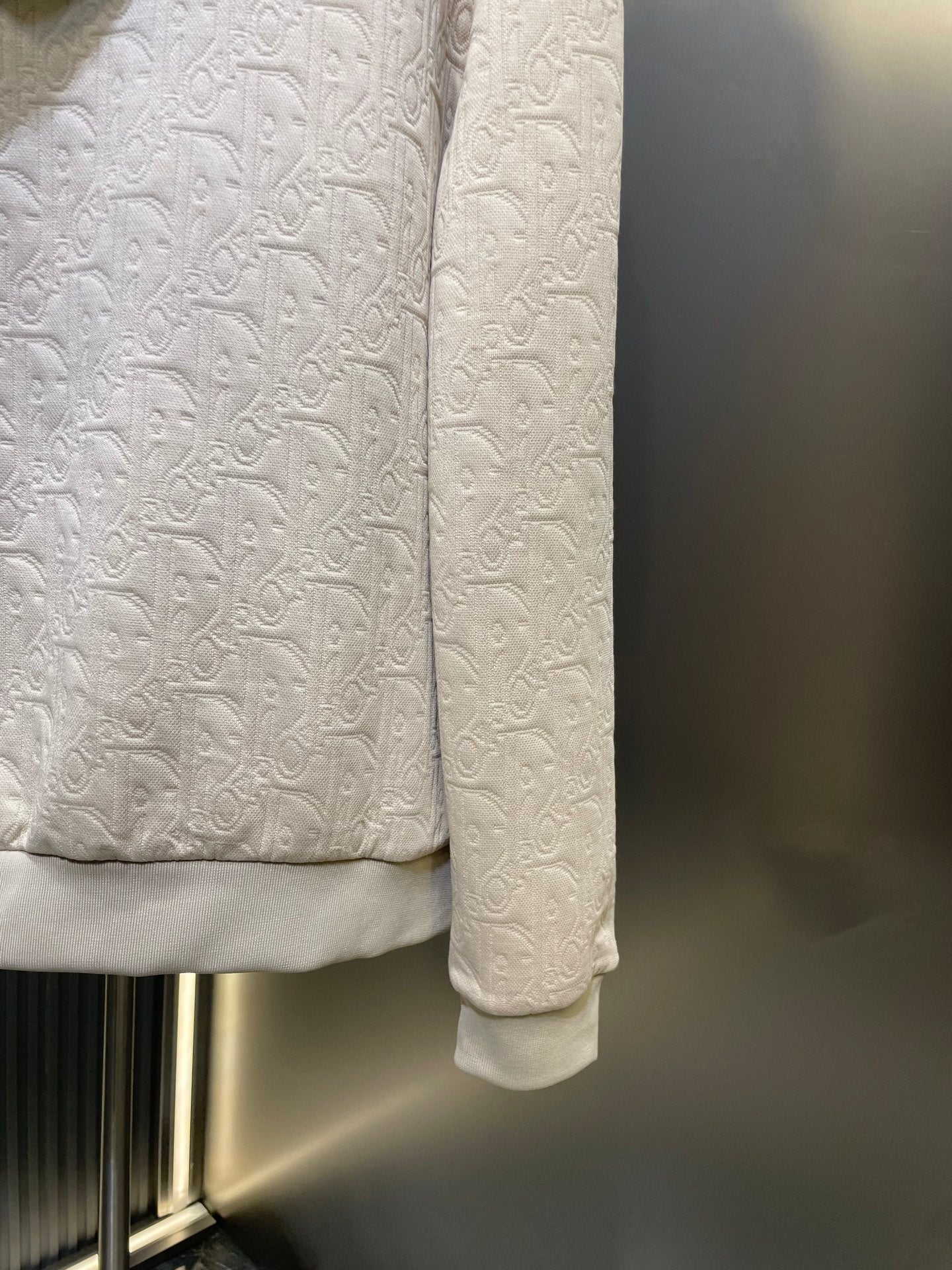 Cream embossed hoodie hem and sleeve cuffs
