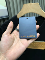 Louis Vuitton hang tag card over black T-shirt