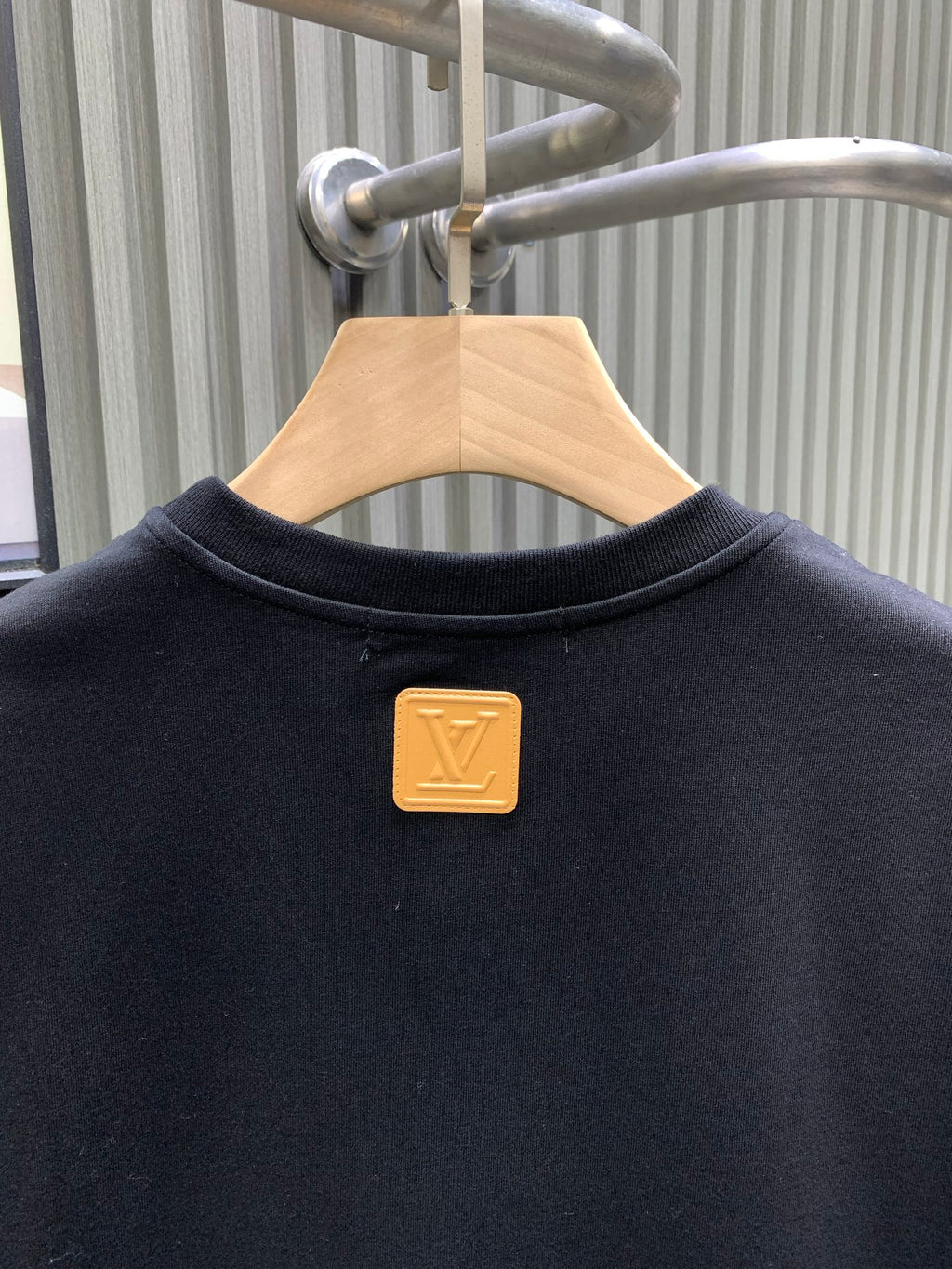 Louis Vuitton black T-shirt with gold logo pin and crew neckline