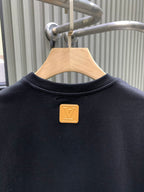 Louis Vuitton black T-shirt with gold logo pin and crew neckline