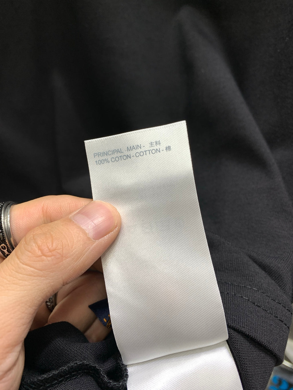 Black shorts with white care label showing 100% cotton