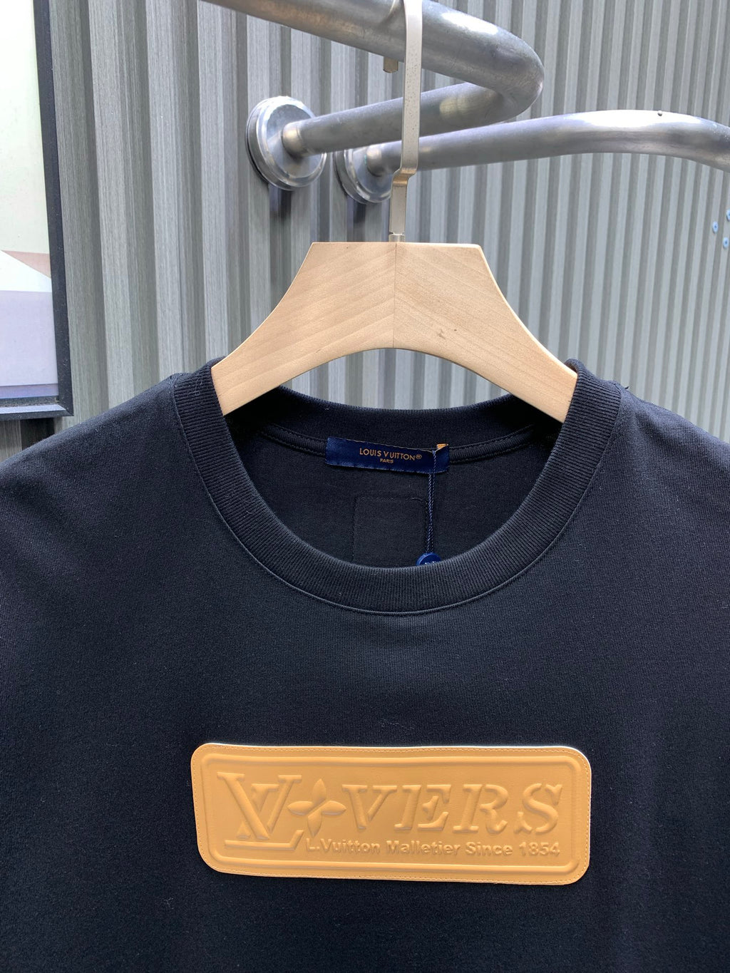 Louis Vuitton black T-shirt with gold LV embossed logo at chest