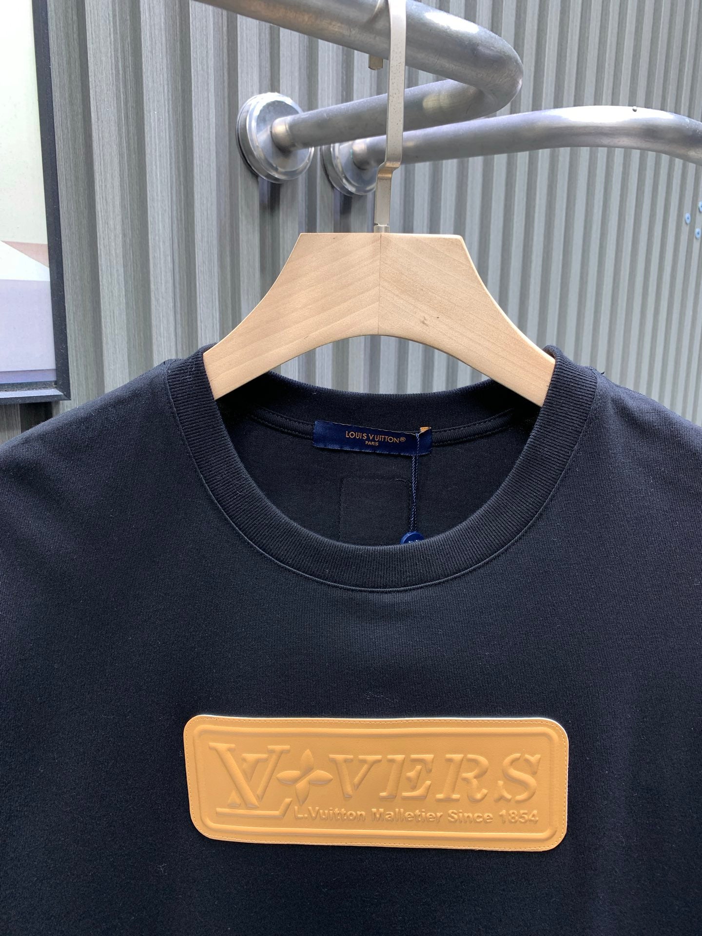 Louis Vuitton black T-shirt with gold LV embossed logo at chest