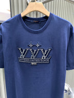 Blue T-shirt front with crown graphic and crew neckline on hanger.