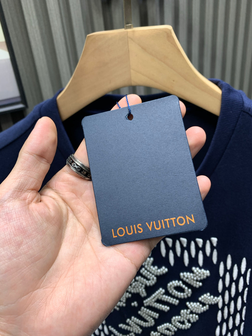 Navy short-sleeve T-shirt with Louis Vuitton hang tag