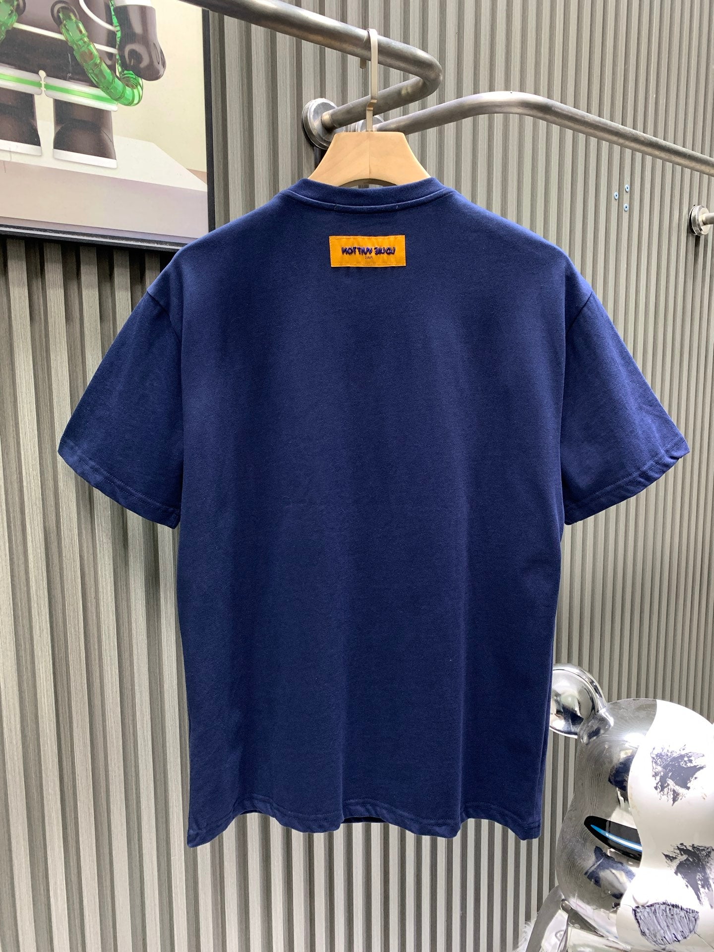 Navy short-sleeve T-shirt with yellow brand label at back neckline