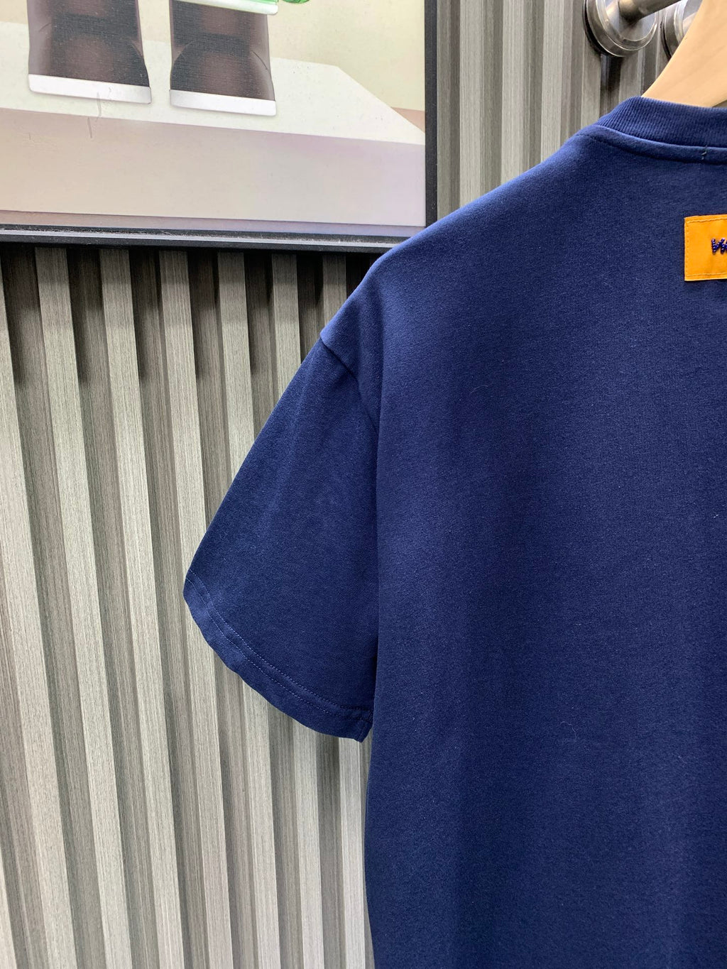 Navy short-sleeve T-shirt back with yellow label near collar