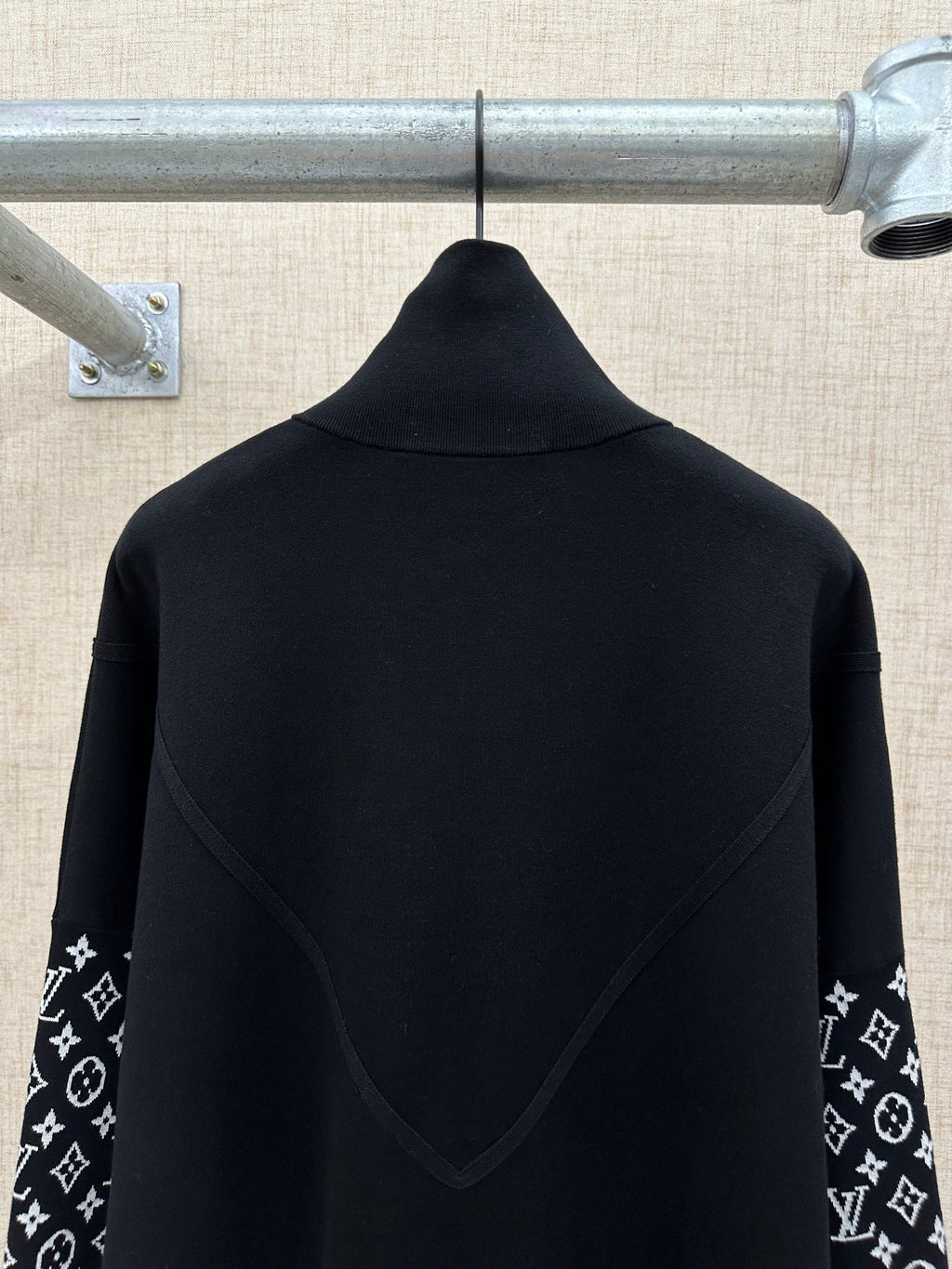 Black jacket back with high collar and logo-print sleeve panels