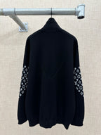 Black back view jacket with high collar and logo-print sleeve panels