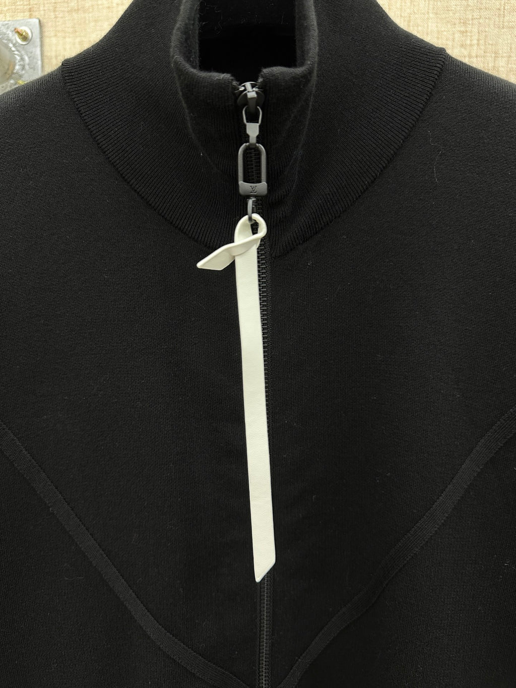 Black jacket high collar with white zipper pull