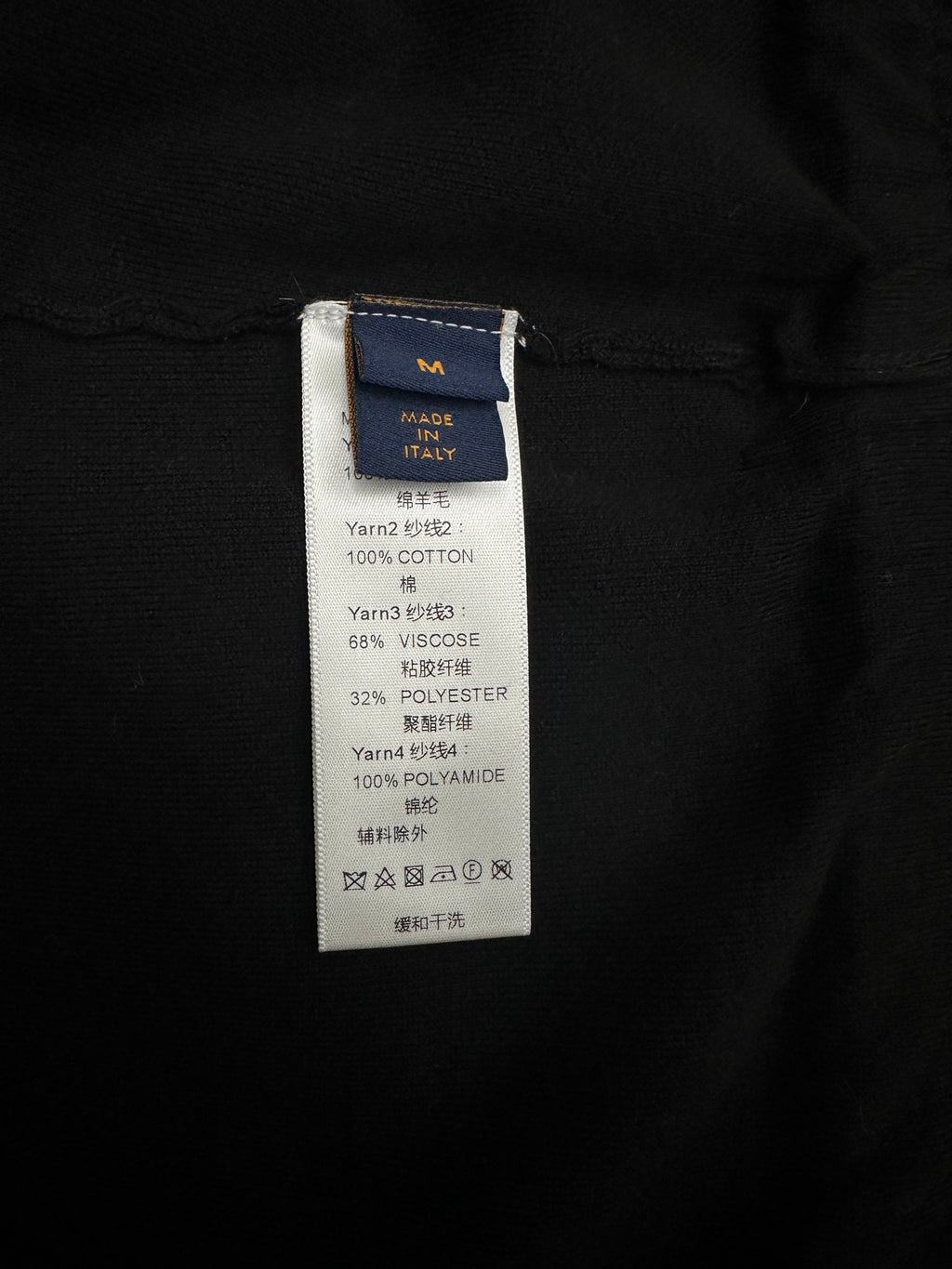 Black jacket care and material label with size tag