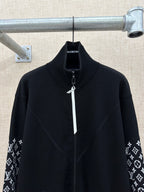 Black zip-front jacket with high collar and logo-print cuffs