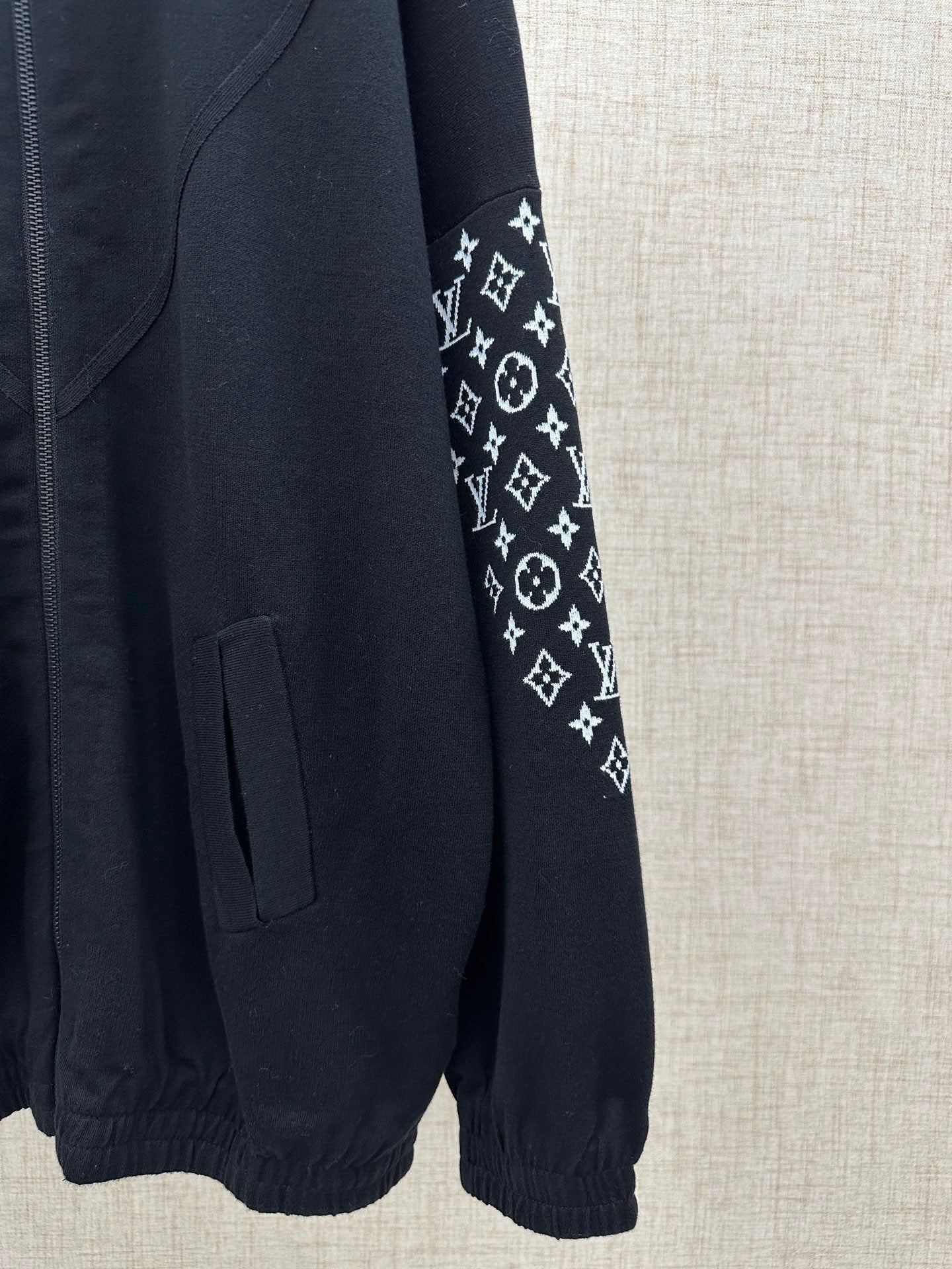 Black jacket with logo-print sleeve panel and front patch pocket