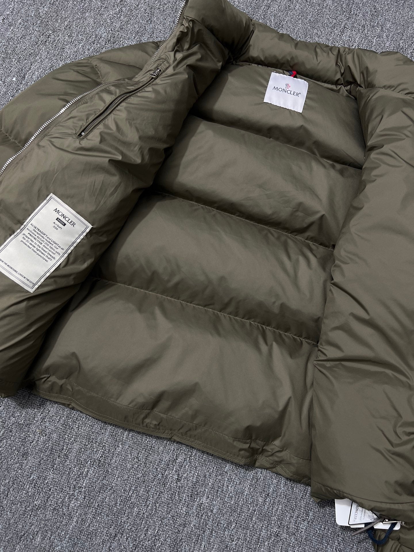 Long puffer jacket open interior with quilted baffles and size label