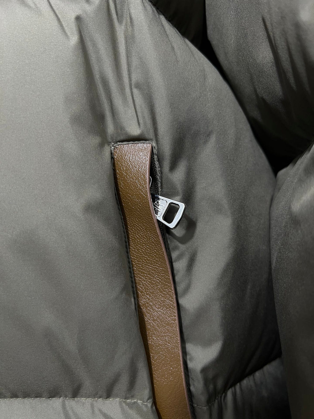 Puffer jacket front with brown leather-look trim and silver-tone snap detail