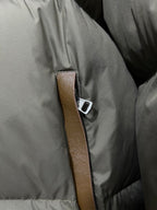 Puffer jacket front with brown leather-look trim and silver-tone snap detail