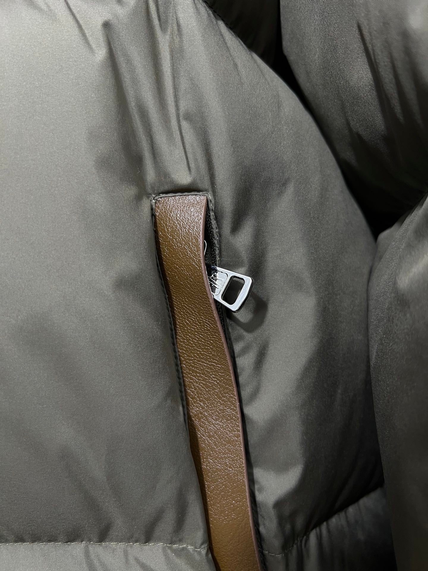Puffer jacket front with brown leather-look trim and silver-tone snap detail