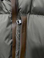 Puffer jacket zipper with Moncler logo fabric tab and leather-look pull strap