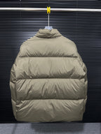 Long puffer jacket back view with hood, hanging on a hanger