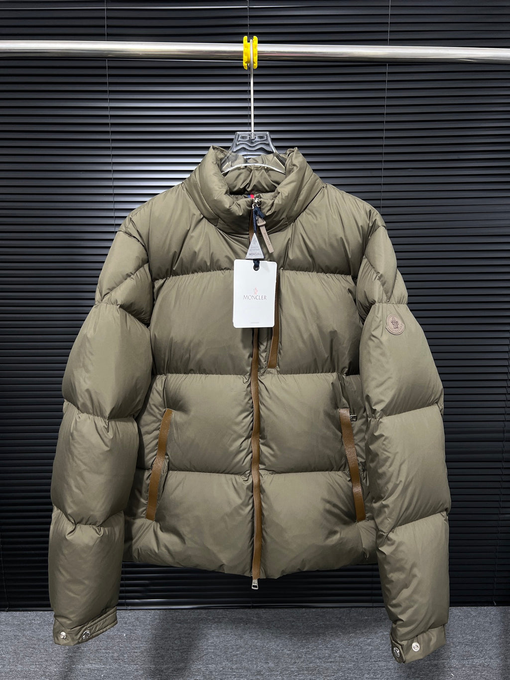 Moncler long puffer jacket in olive with front zip and high collar