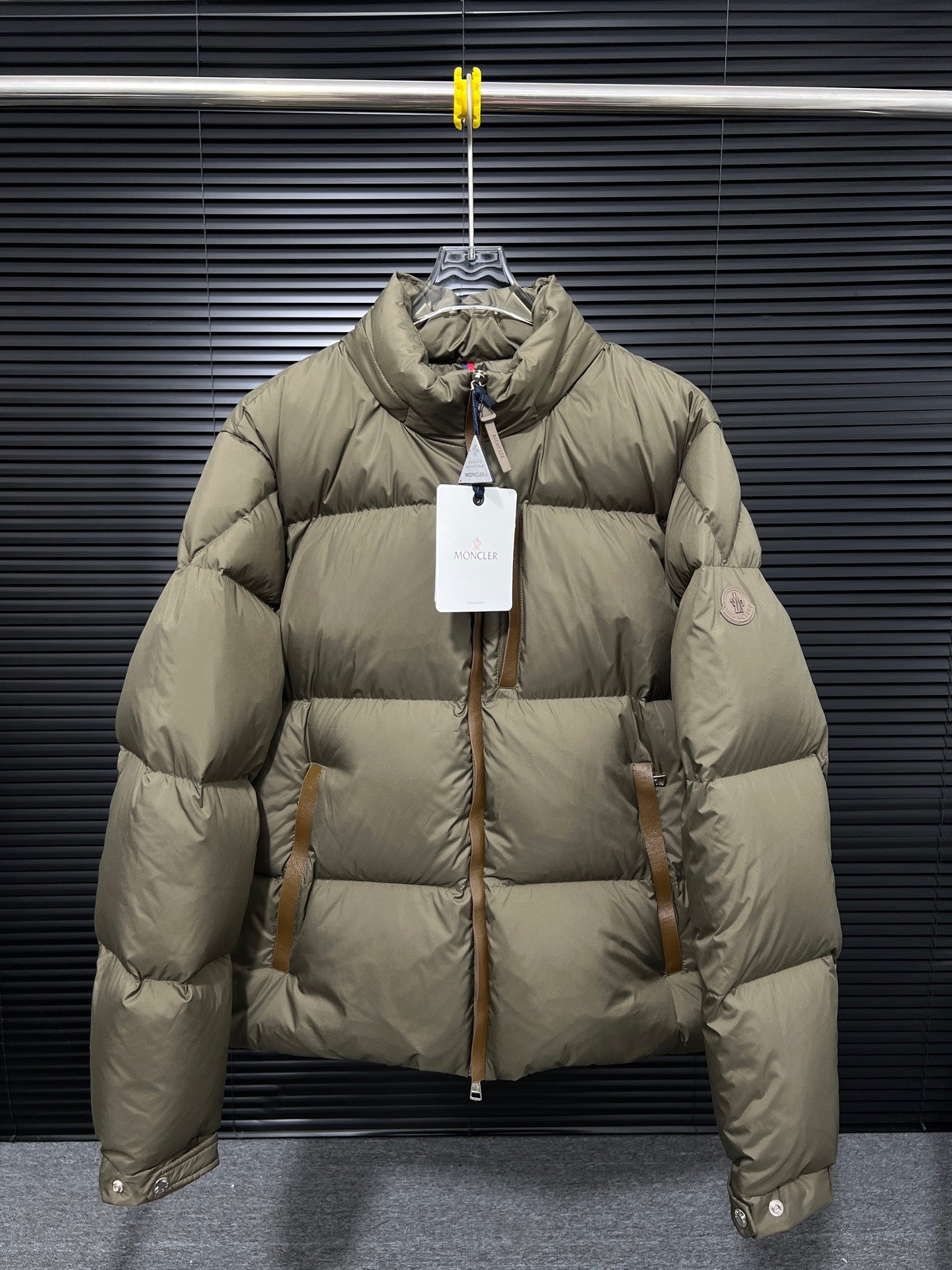 Moncler long puffer jacket in olive with front zip and high collar